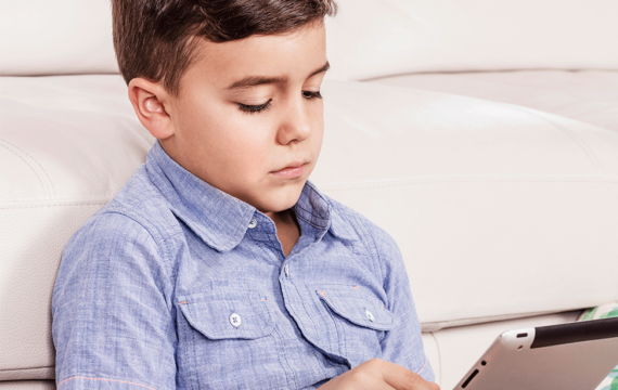 boy holding an ipad