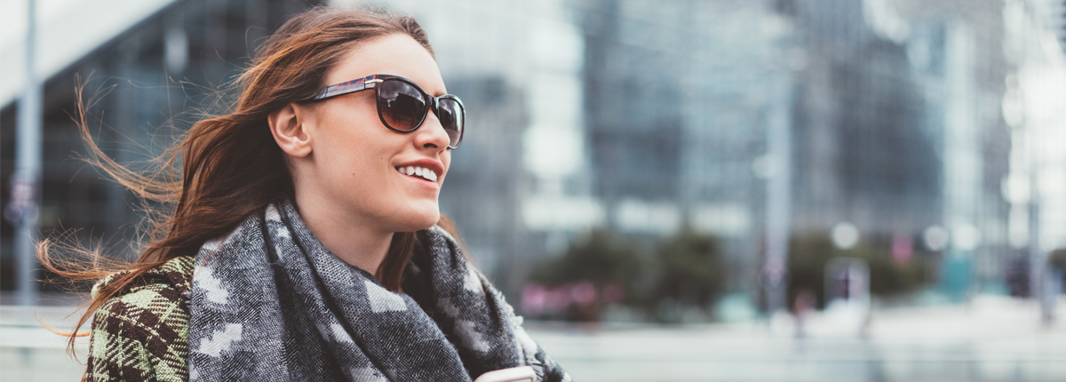 smiling woman wearing sunglasses for uv protection