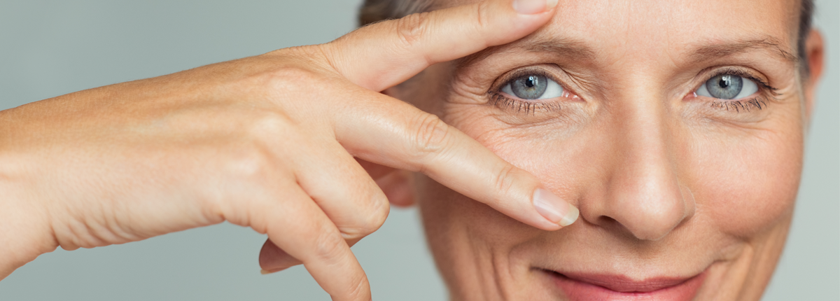smiling woman doing victory sign on eye